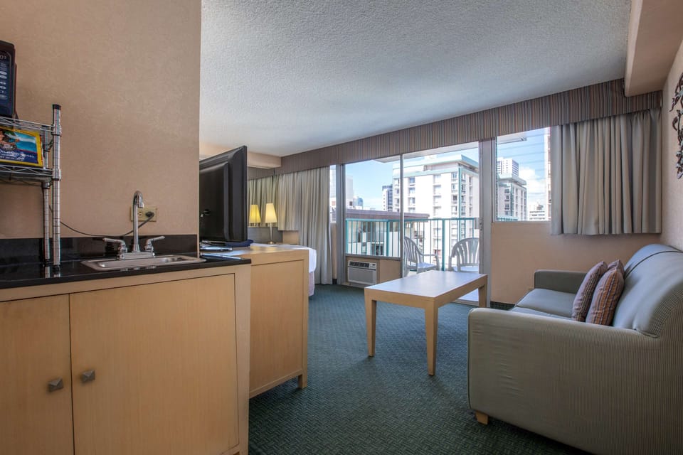 Deluxe Room | Living area | 40-inch LCD TV with cable channels, TV, DVD player