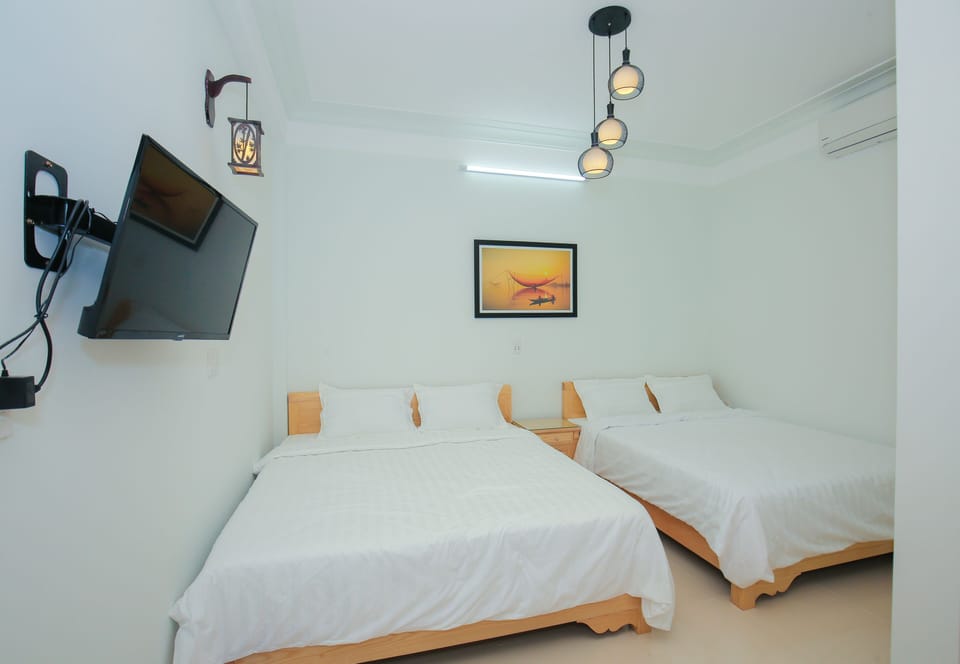 Standard Quadruple Room, City View | Minibar, individually decorated, individually furnished, desk