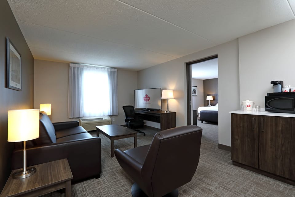 Deluxe Room | Desk, laptop workspace, blackout drapes, iron/ironing board