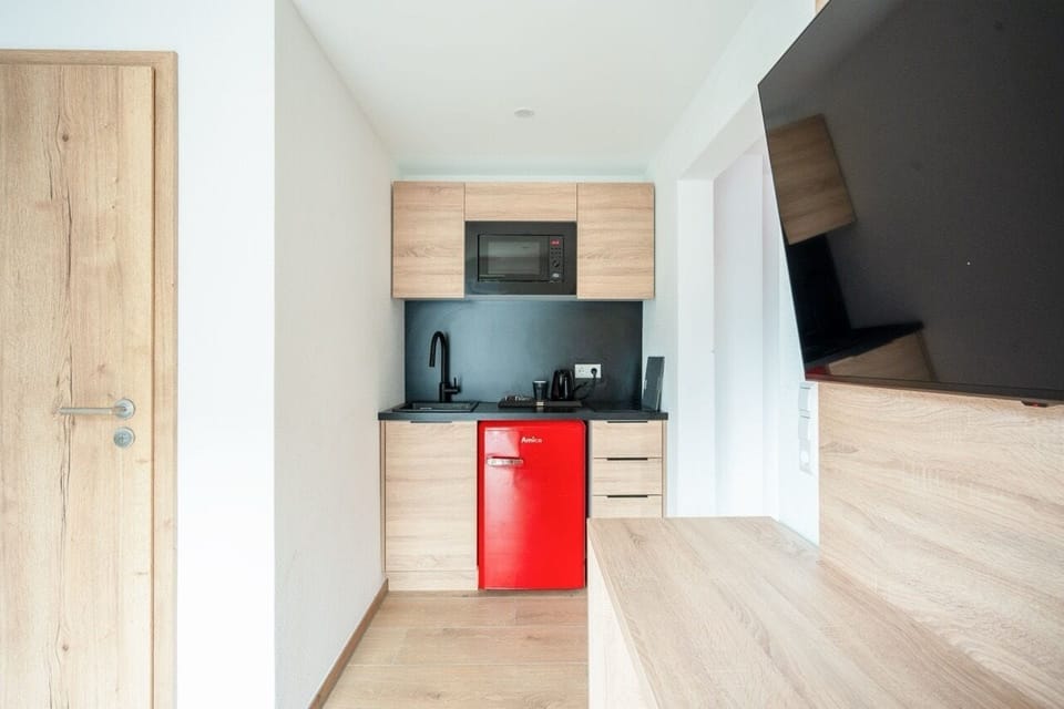 Family Studio | Living area | Flat-screen TV, heated floors