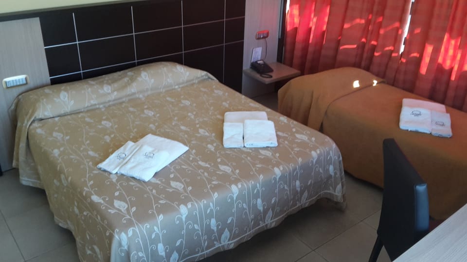 Triple Room | Minibar, individually furnished, desk, blackout drapes