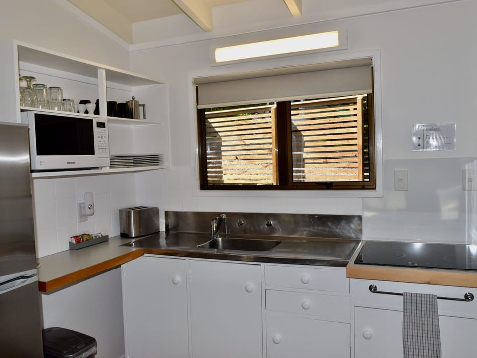Two Bedroom Unit | Private kitchenette | Microwave, highchair, cleaning supplies
