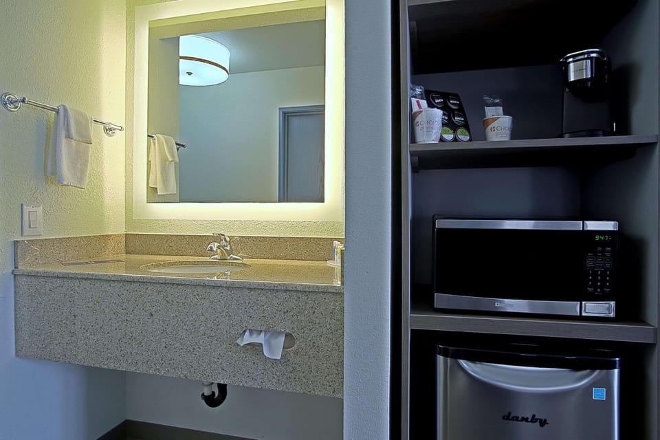 Desk, laptop workspace, blackout drapes, iron/ironing board