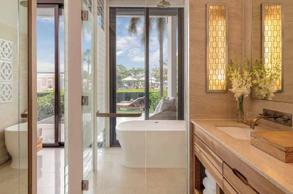 Deep soaking tub, rainfall showerhead, designer toiletries, hair dryer