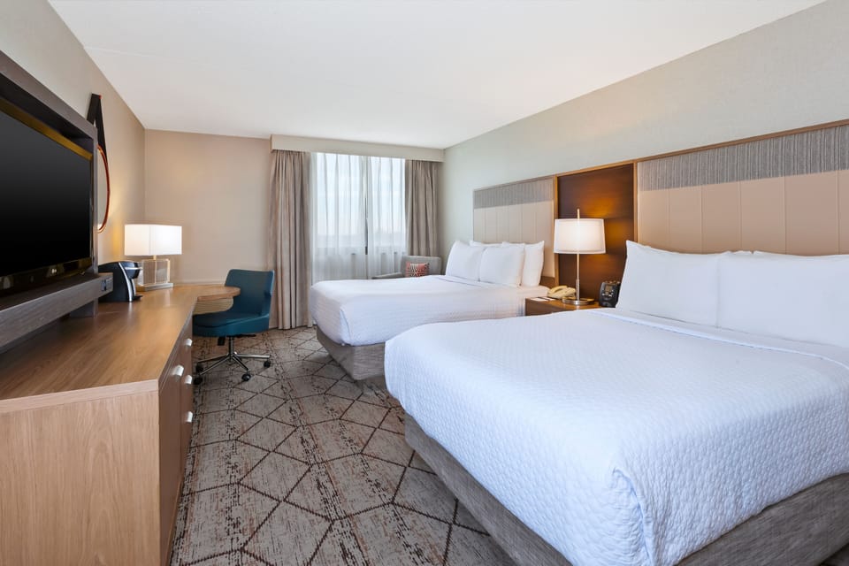 Hypo-allergenic bedding, desk, laptop workspace, blackout drapes