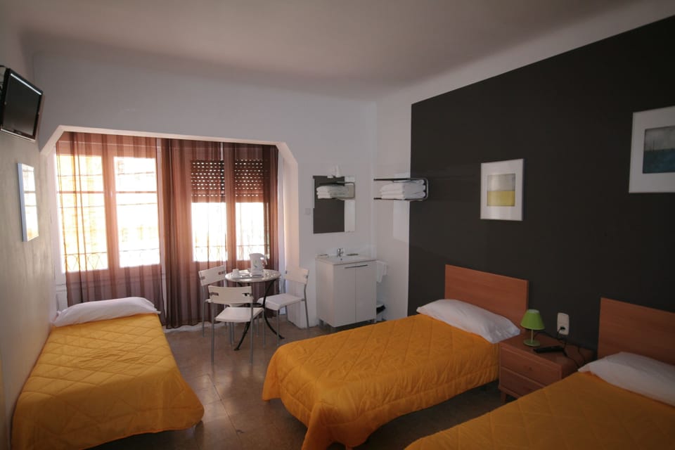 Triple Room, Shared Bathroom | Desk, blackout drapes, free cribs/infant beds, free WiFi