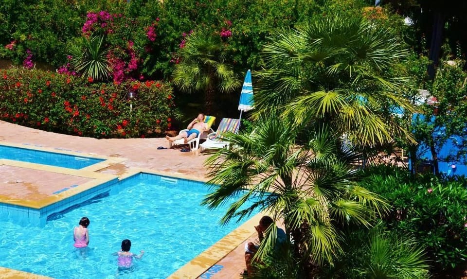 Seasonal outdoor pool, open 10:00 AM to 6:30 PM, pool umbrellas