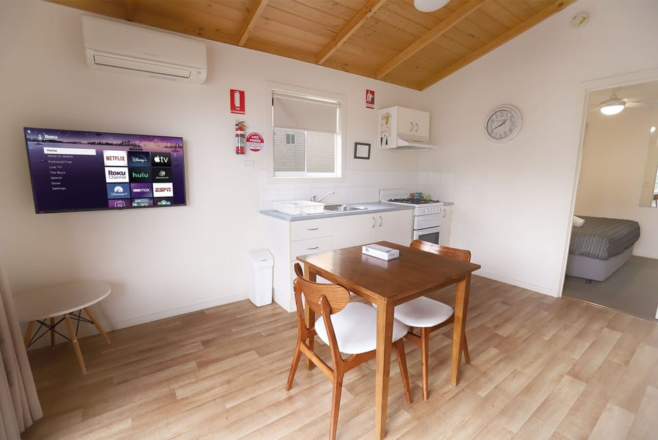 Classic One-Bedroom King Cabin | Living area | 30-inch LCD TV with satellite channels