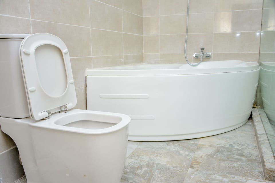 Executive Suite, 1 King Bed | Bathroom | Separate tub and shower, rainfall showerhead, designer toiletries
