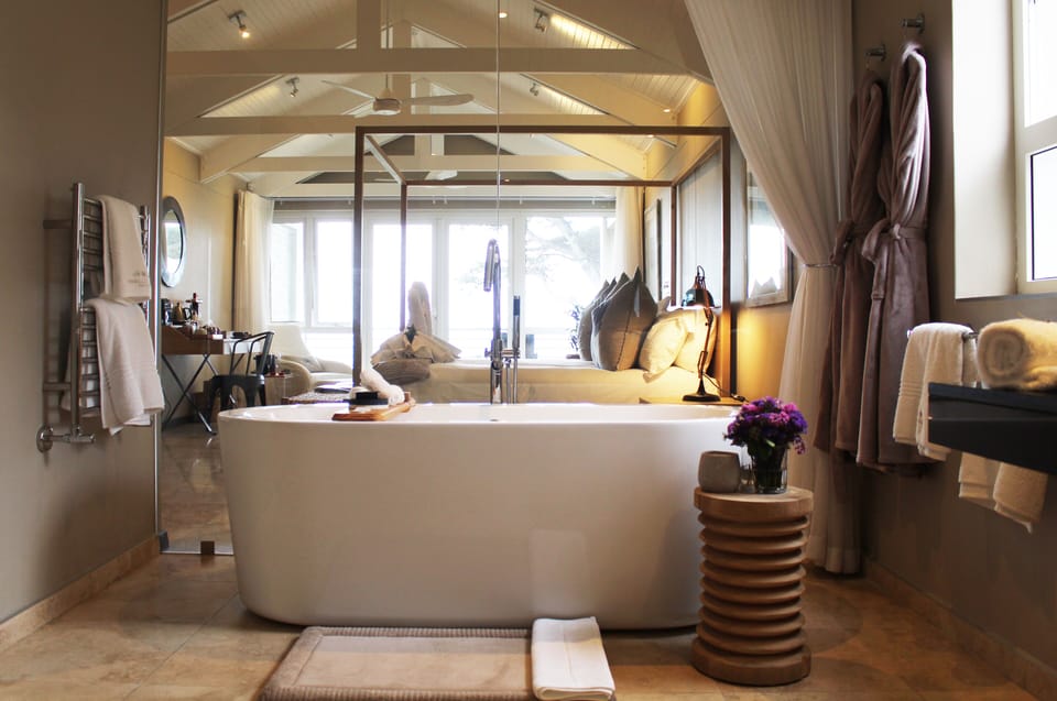 Honeymoon Suite | Bathroom | Designer toiletries, hair dryer, bathrobes, slippers