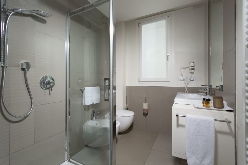 Shower, rainfall showerhead, designer toiletries, hair dryer