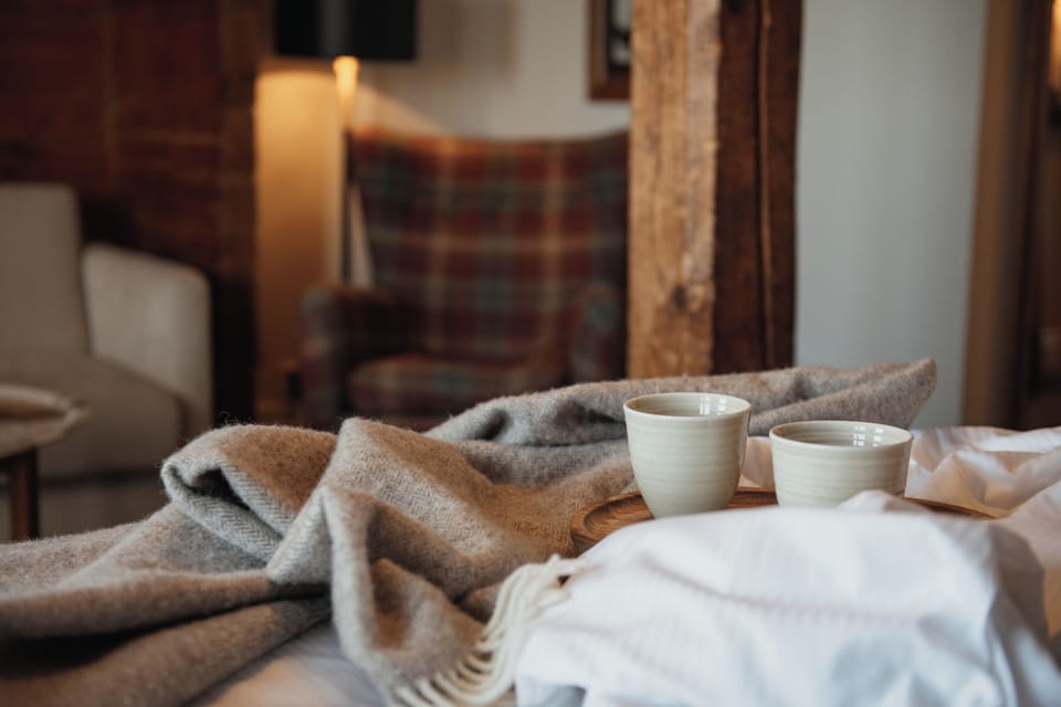 Desk, laptop workspace, iron/ironing board, bed sheets