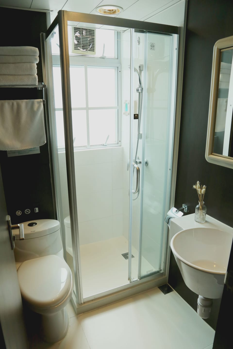 Shower, hair dryer, slippers, towels