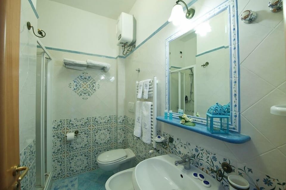 Double Room, Balcony, Partial Sea View | Bathroom | Shower, rainfall showerhead, free toiletries, hair dryer