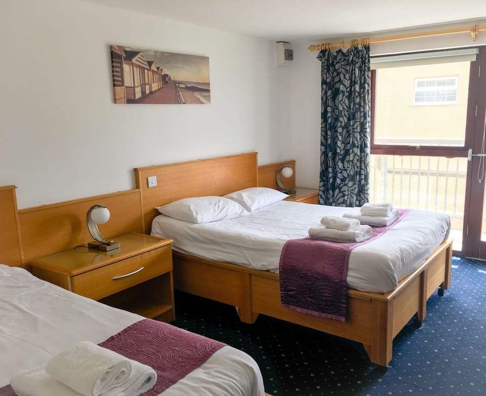Family Room | Desk, blackout drapes, free WiFi, bed sheets