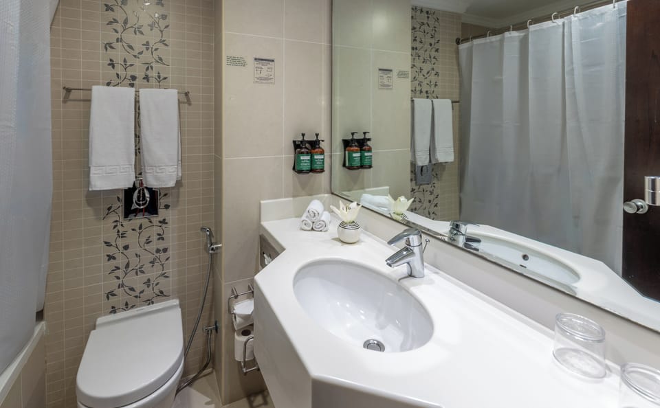 Bathtub, hair dryer, bathrobes, slippers