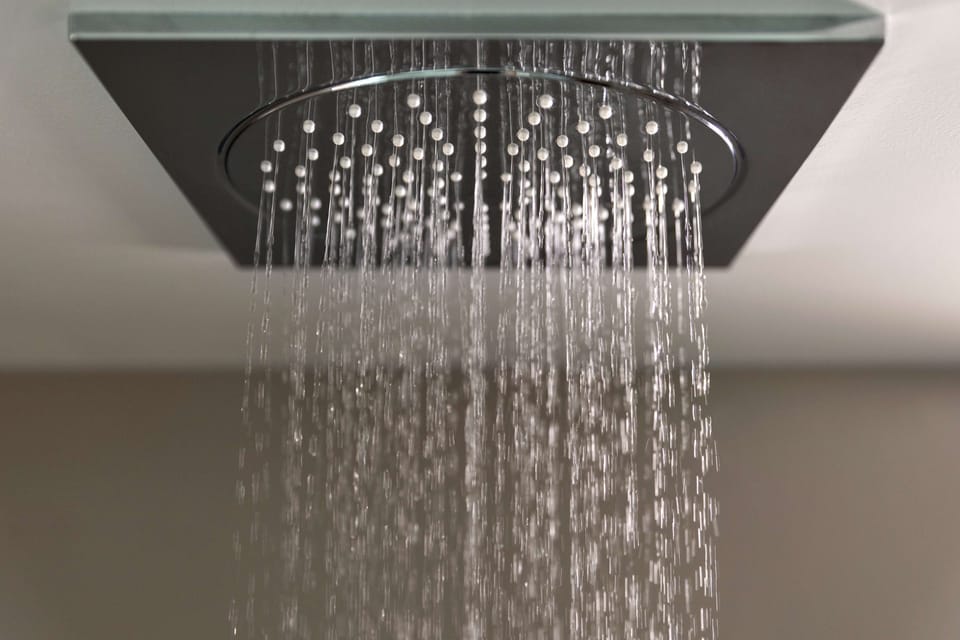 Shower, rainfall showerhead, hair dryer, towels