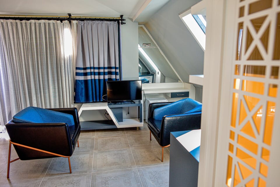 Deluxe Double Room | Living area | LCD TV