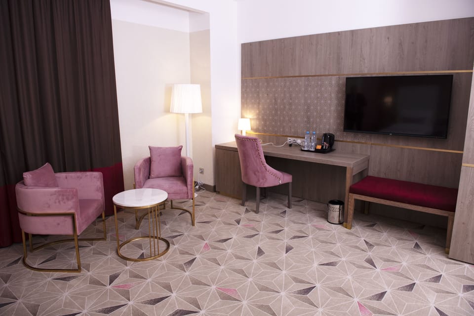Junior Suite | Living area | 49-inch Smart TV with satellite channels, TV