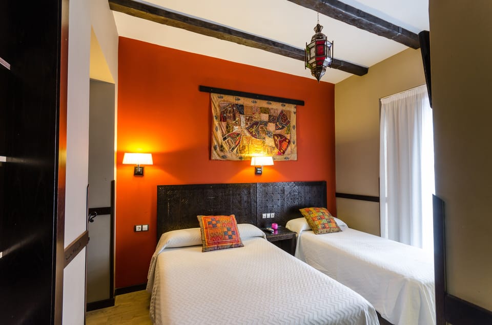 Triple Room | Down comforters, in-room safe, desk, blackout drapes