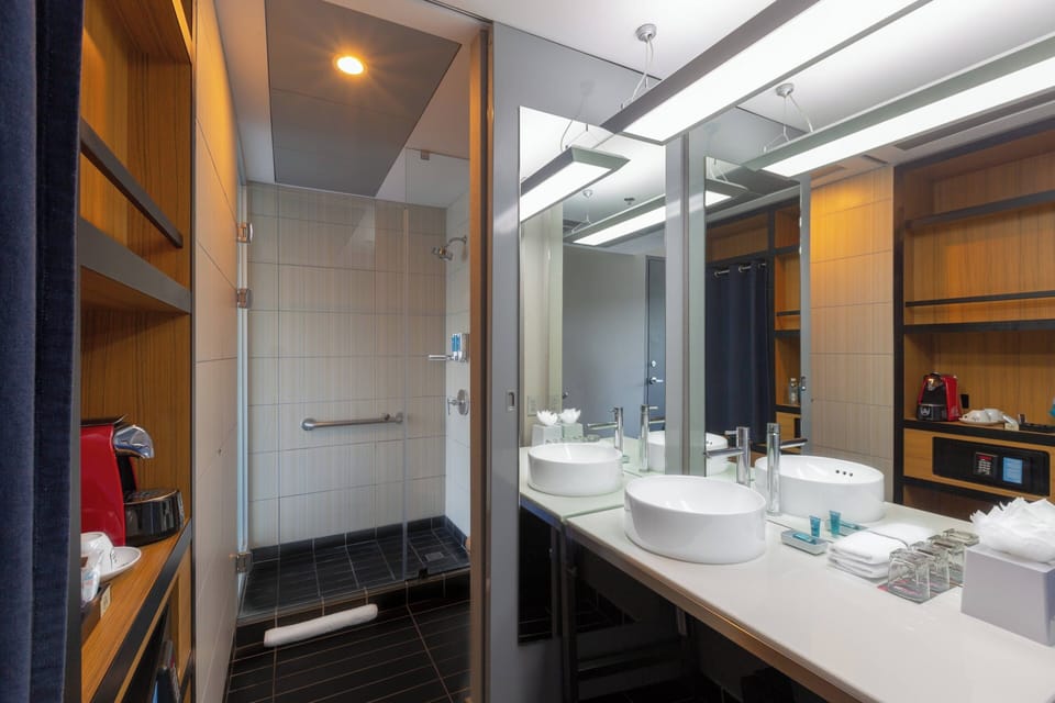 Shower, designer toiletries, hair dryer, towels