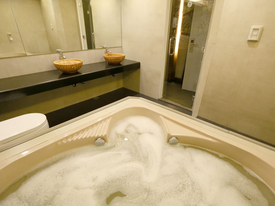 Suite, 1 Queen Bed | Bathroom | Shower, free toiletries, hair dryer, slippers