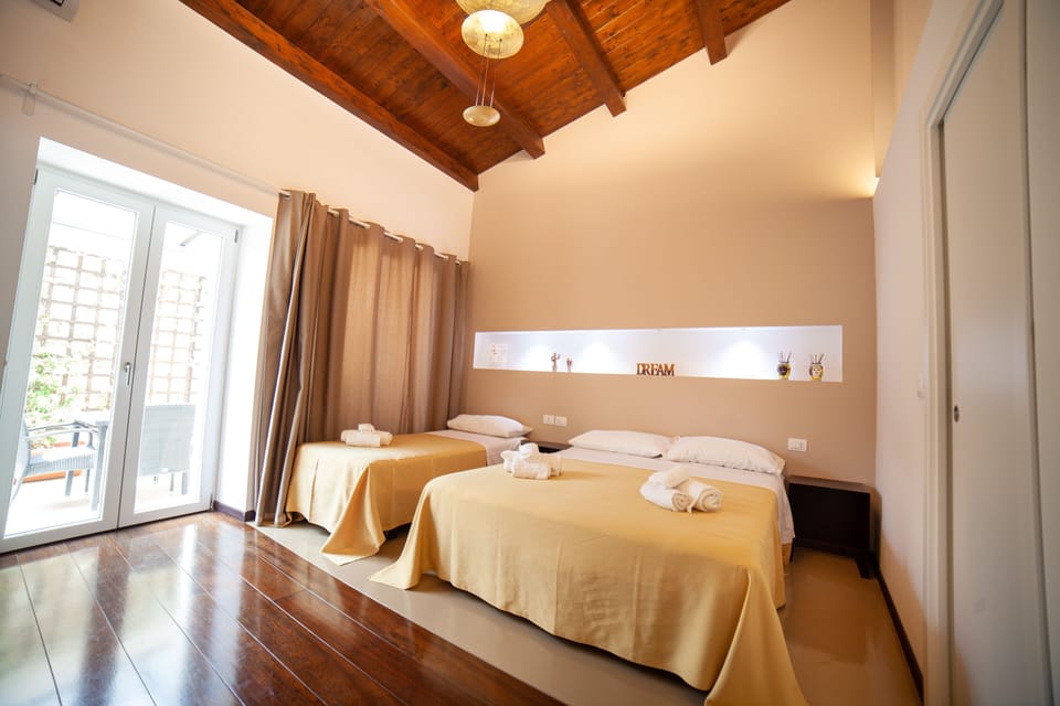 Triple Room, Patio | Down comforters, minibar, in-room safe, individually decorated