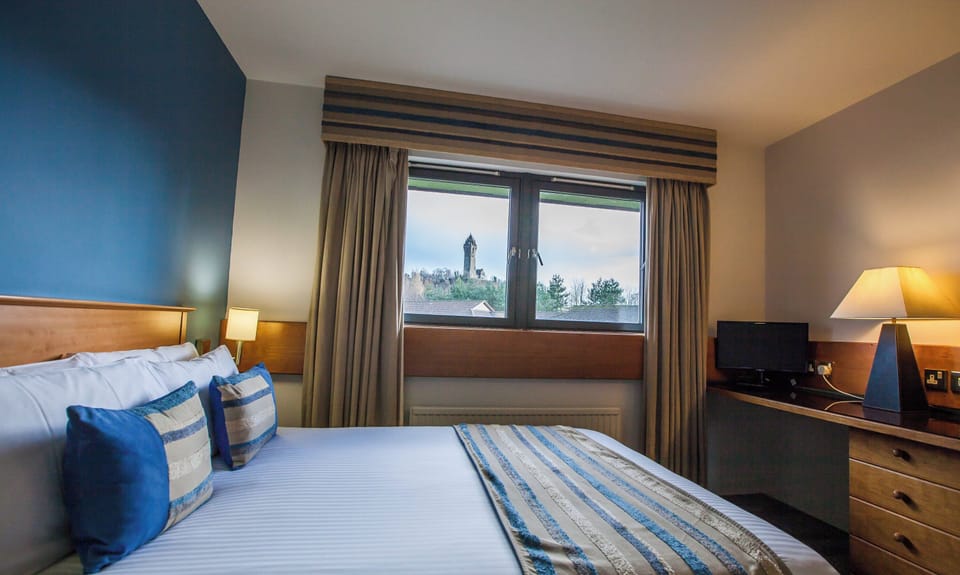 Premium bedding, desk, laptop workspace, iron/ironing board