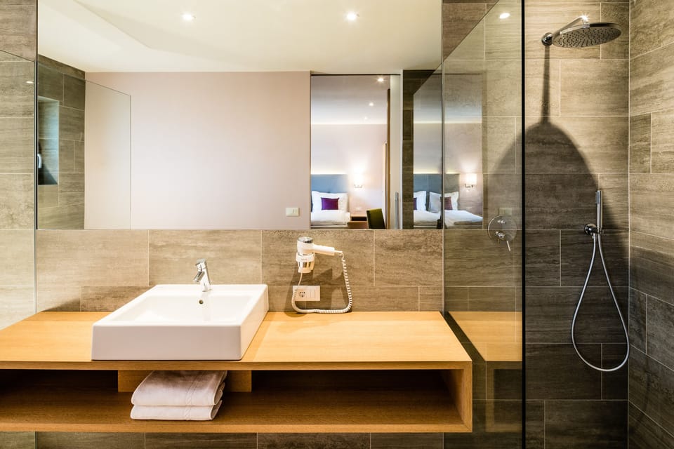 Junior Suite, 1 Queen Bed, Non Smoking, Pool View | Bathroom | Shower, designer toiletries, hair dryer, bathrobes