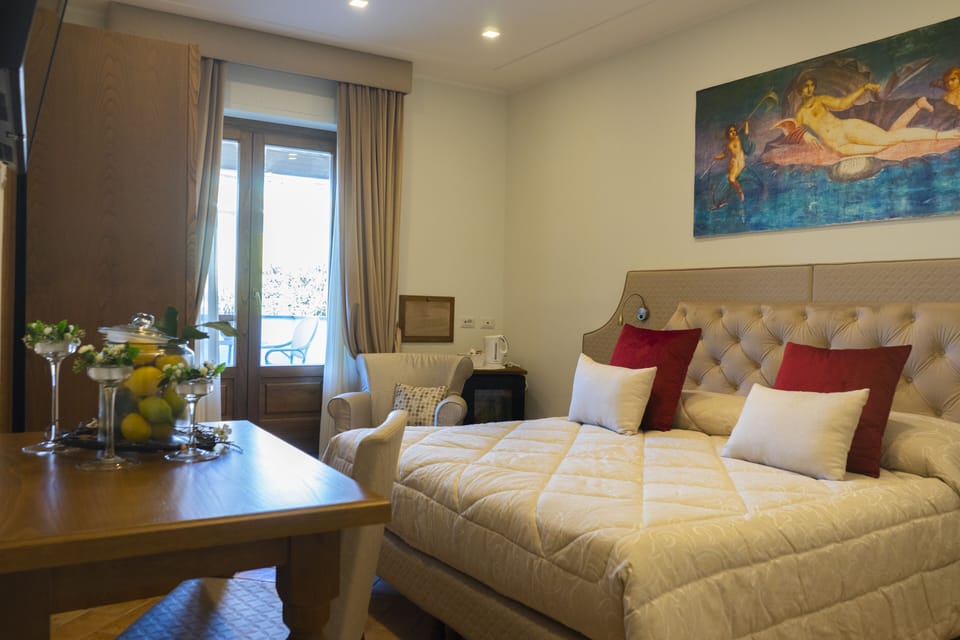 Deluxe Triple Room | Minibar, in-room safe, desk, laptop workspace