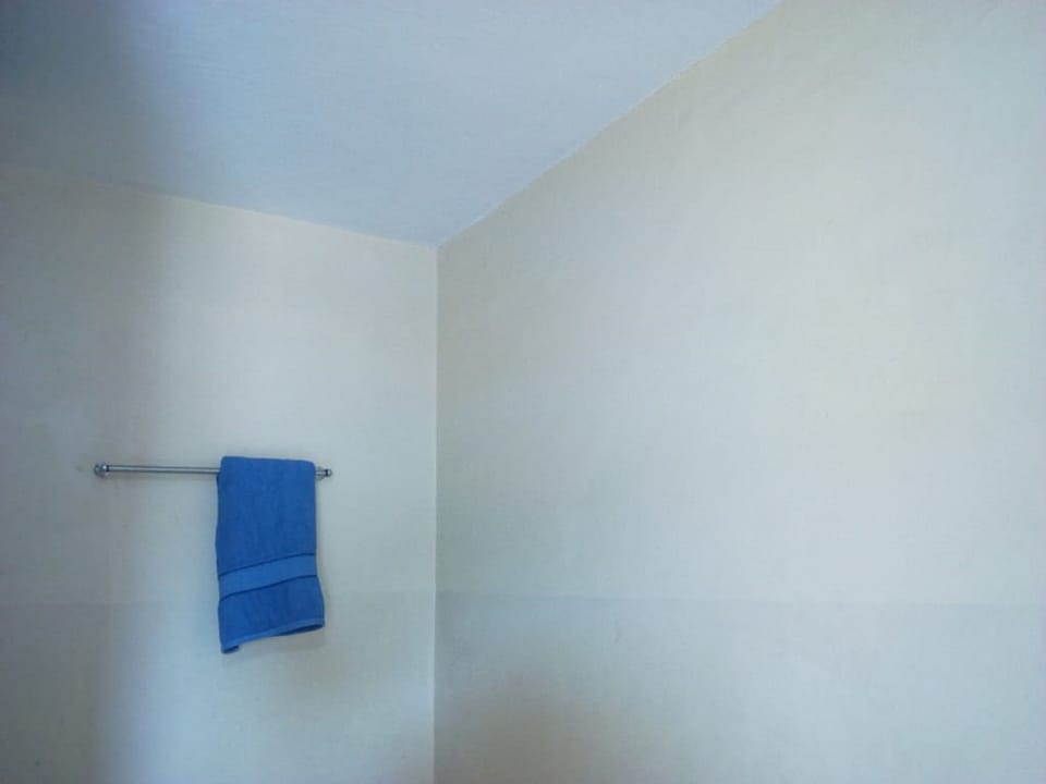 Shower, rainfall showerhead, slippers, towels