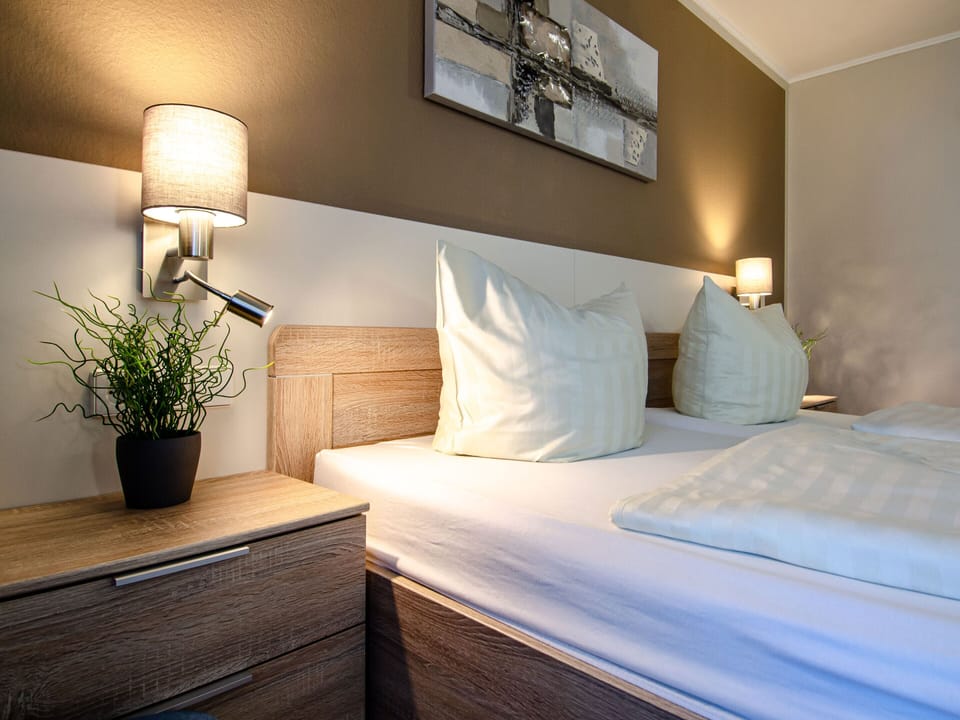 Hypo-allergenic bedding, desk, laptop workspace, blackout drapes