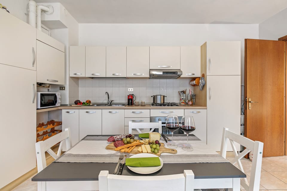 Family Apartment, Multiple Bedrooms (Petalo Bianco 100m from lake) | Private kitchen | Full-size fridge, microwave, oven, stovetop