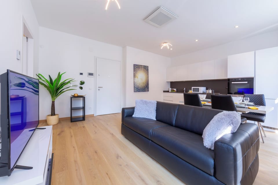 Family Apartment, 1 Bedroom, Balcony (Heart of Lugano) | Living area | 22-inch flat-screen TV with satellite channels, TV, heated floors