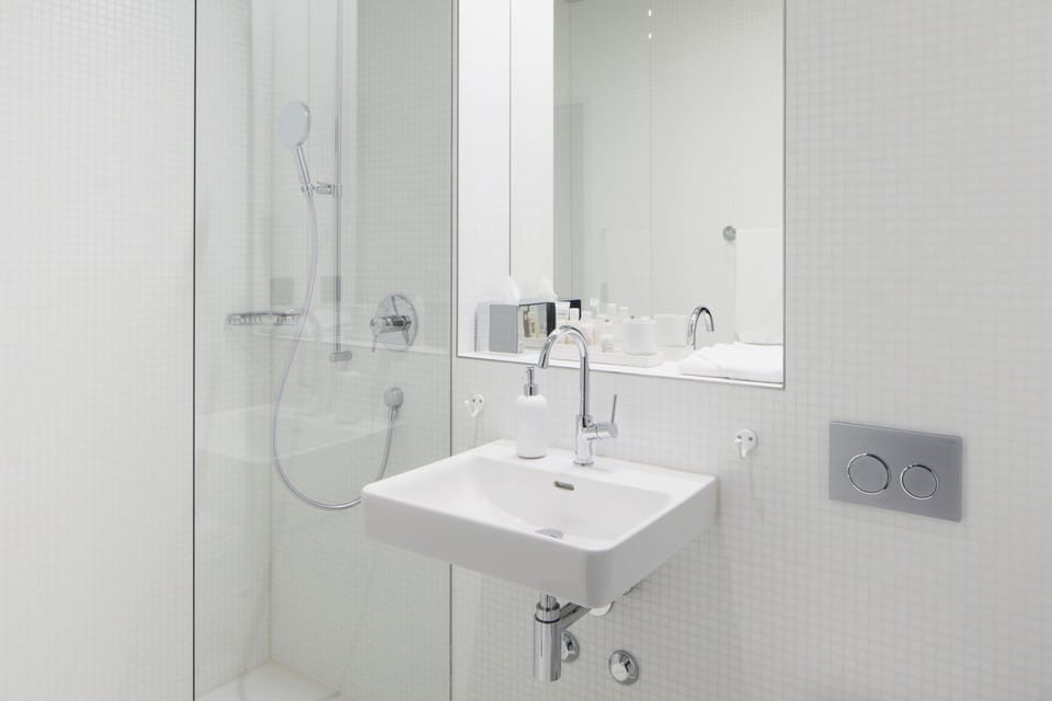 Shower, designer toiletries, hair dryer, slippers