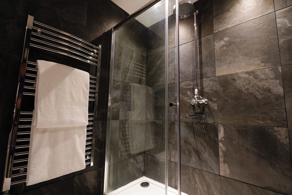 Suite, 1 Double Bed | Bathroom | Hair dryer, towels, soap, shampoo