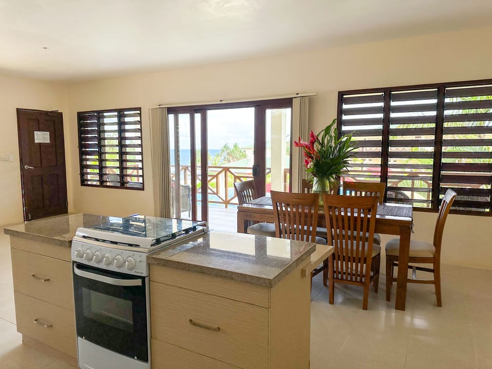 Pool View Two-Bedroom Apartment | Private kitchen | Full-size fridge, coffee/tea maker, electric kettle, toaster