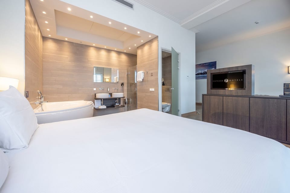 Suite, Lake View | Bathroom | Separate tub and shower, rainfall showerhead, eco-friendly toiletries