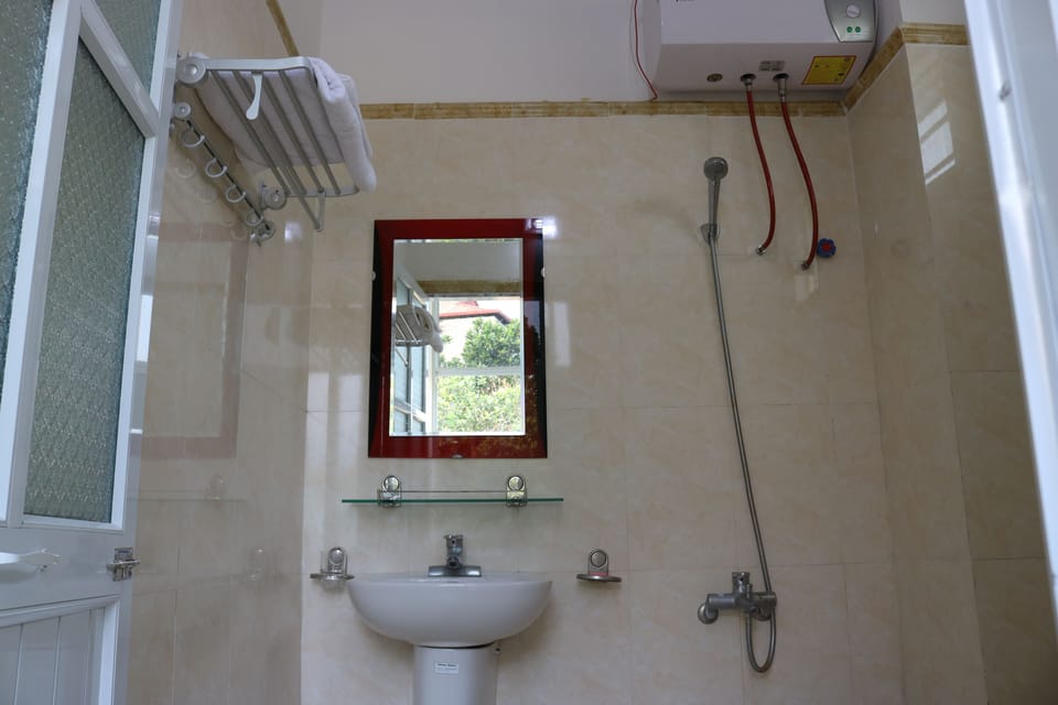 Shower, hair dryer, slippers, towels