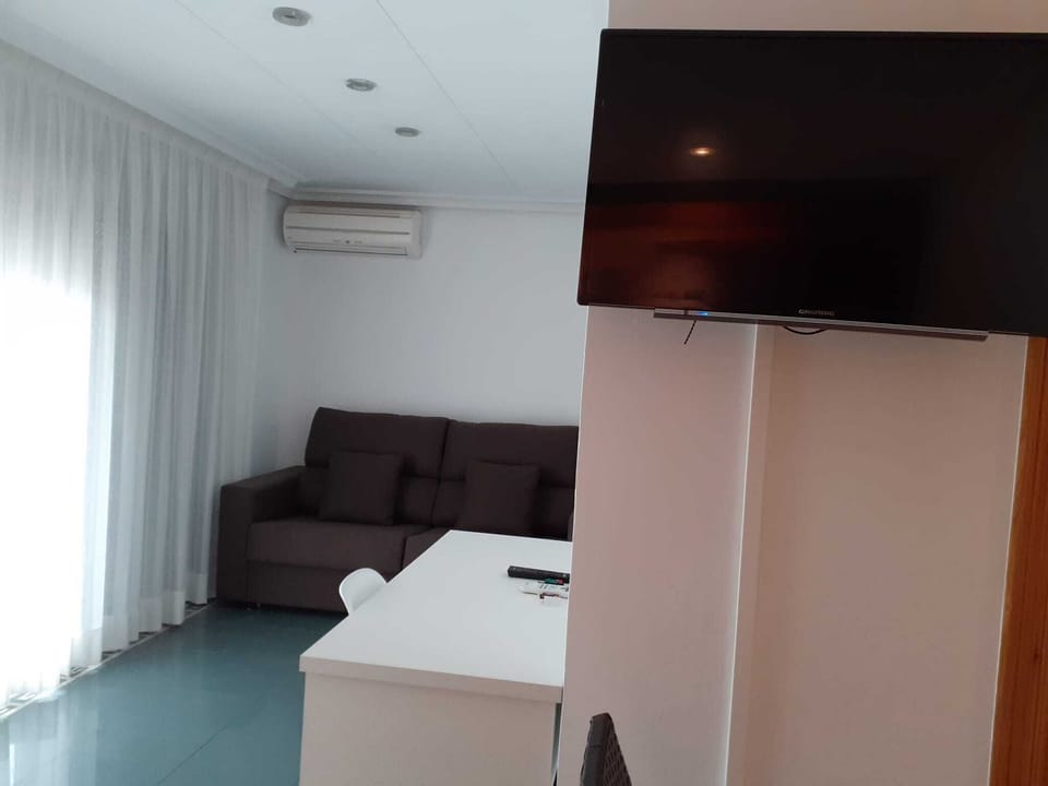 Quadruple room with terrace, 4 people | Living area | TV