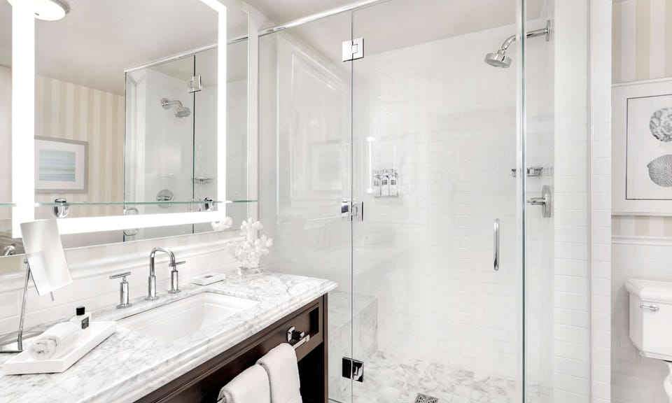 Shower, designer toiletries, hair dryer, bathrobes
