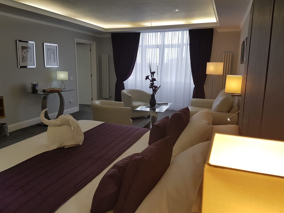 Premium bedding, desk, laptop workspace, iron/ironing board