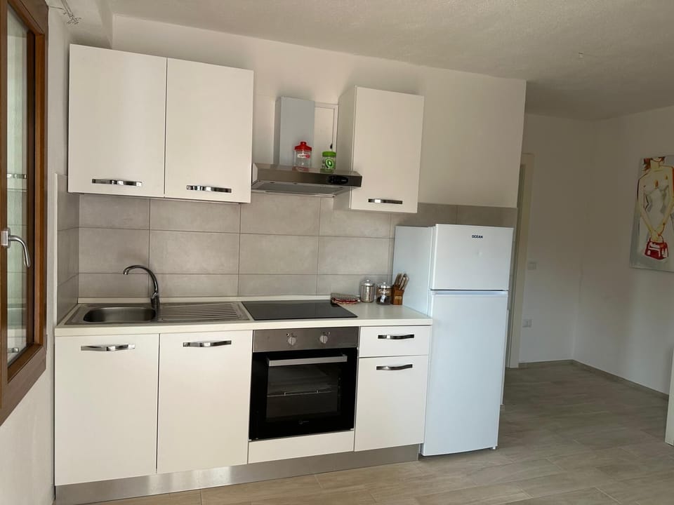 Apartment, 3 Bedrooms | Private kitchen | Full-size fridge, oven, stovetop, cookware/dishes/utensils