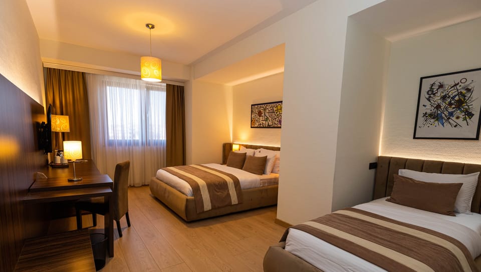 Standard Twin Room | Minibar, in-room safe, desk, soundproofing