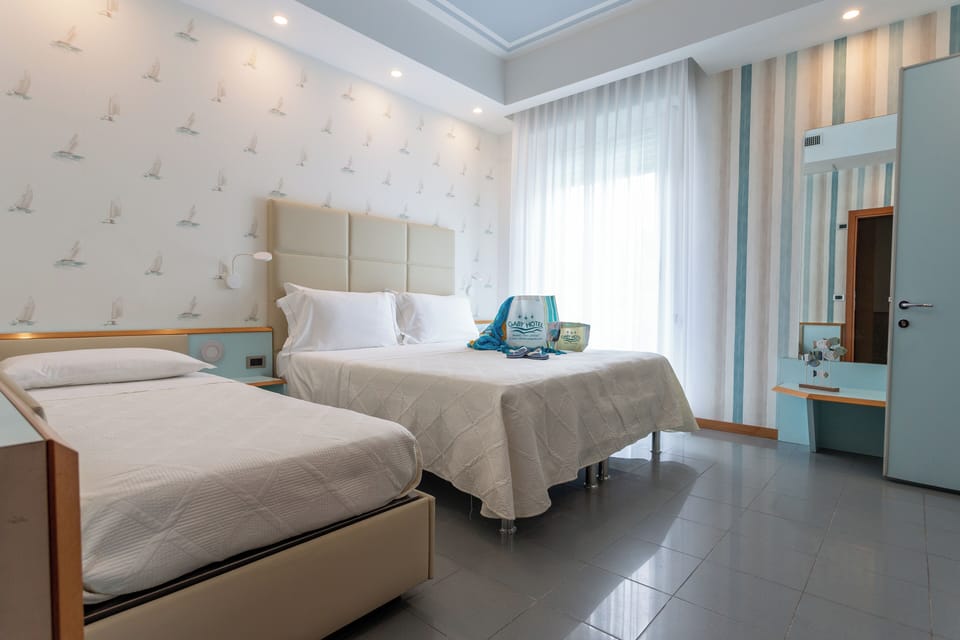 Superior Triple Room | Minibar, in-room safe, desk, laptop workspace