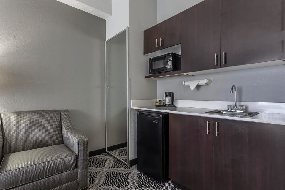 Desk, laptop workspace, blackout drapes, iron/ironing board