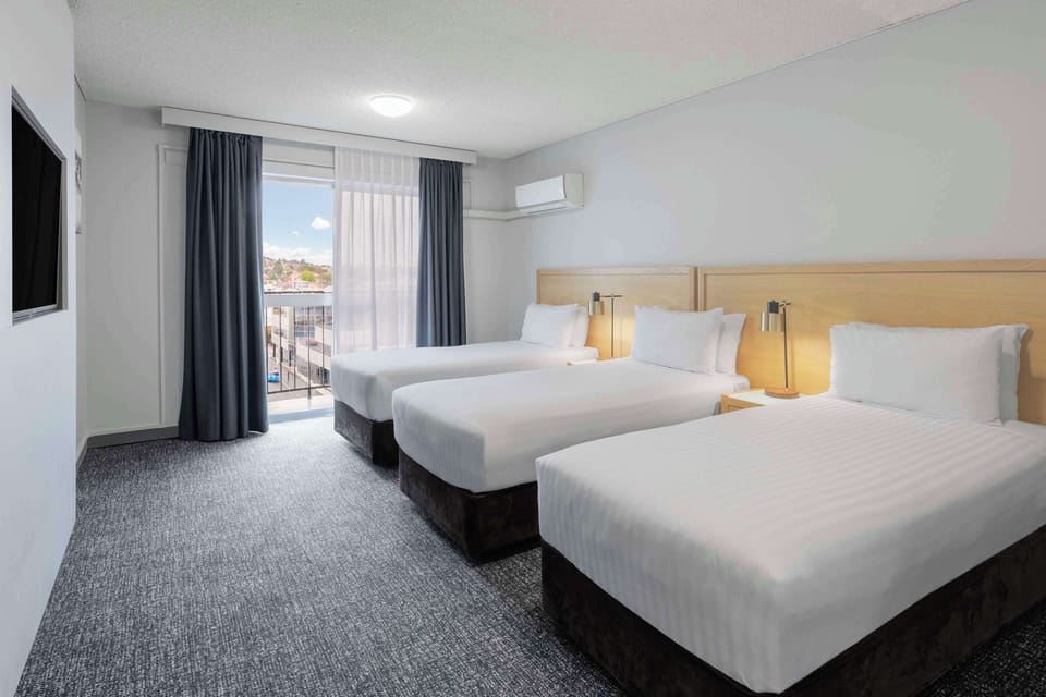 Family Suite, Multiple Beds, Non Smoking, Balcony | Premium bedding, laptop workspace, blackout drapes, iron/ironing board