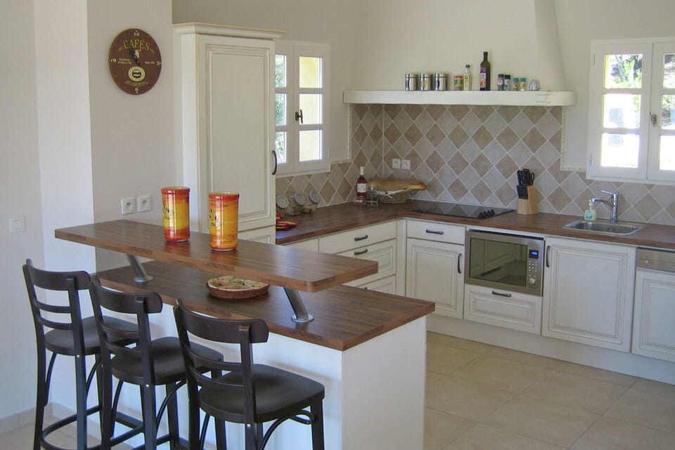 Villa | Private kitchen | Fridge, highchair