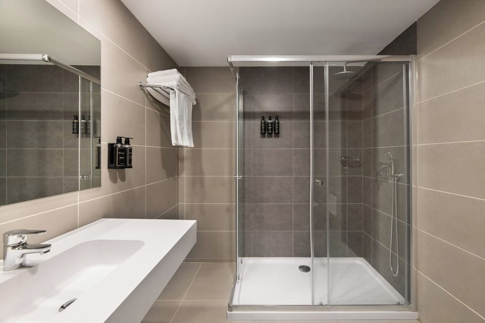 Shower, rainfall showerhead, eco-friendly toiletries, towels