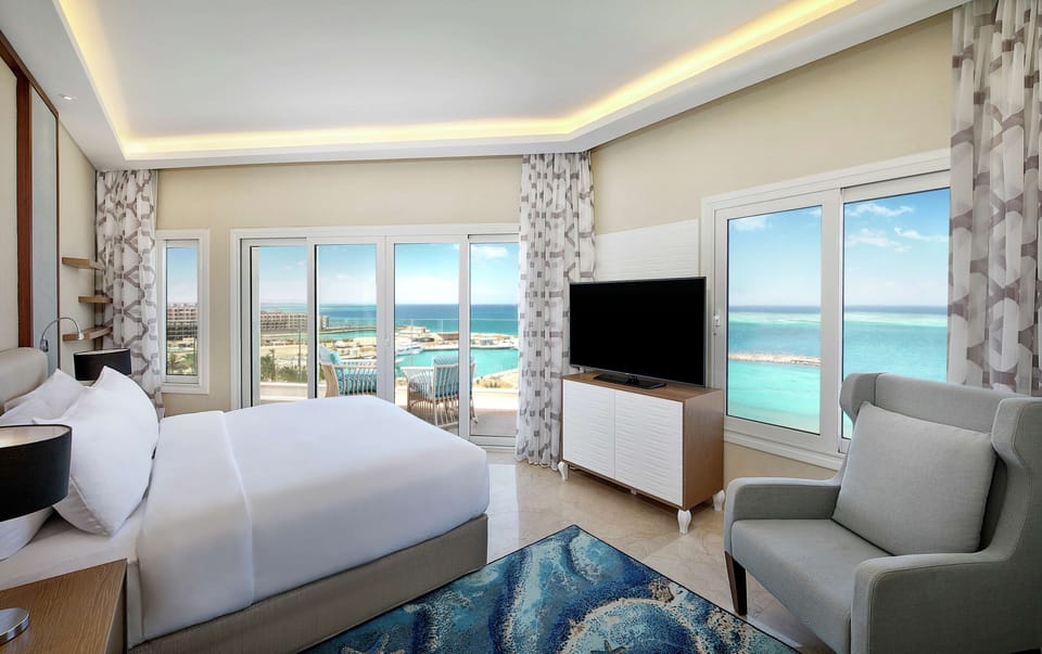 Suite, 1 King Bed, Kitchenette, Sea View (Blue Bay) | Hypo-allergenic bedding, minibar, soundproofing, iron/ironing board